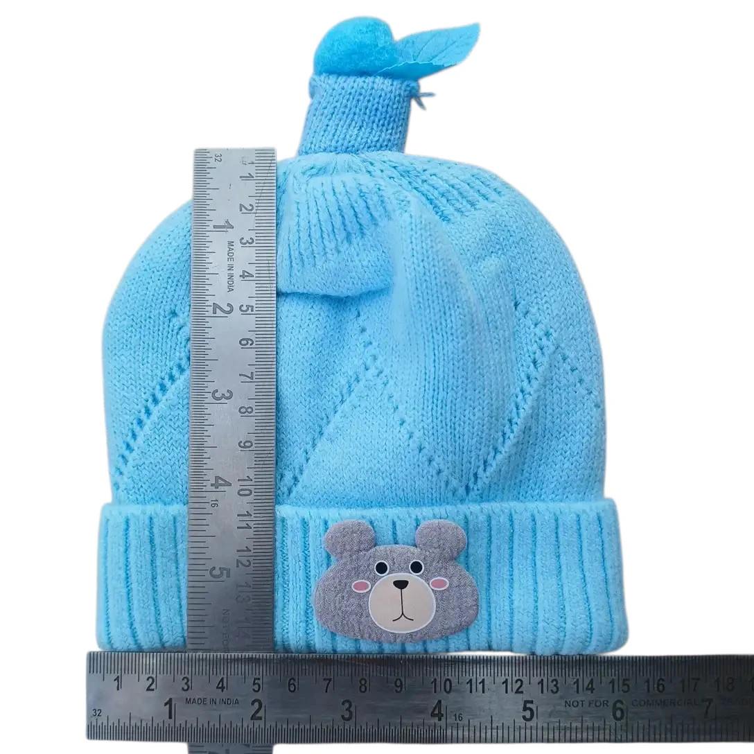 Sky blue knitted winter cap with teddy bear face and decorative blue topper size