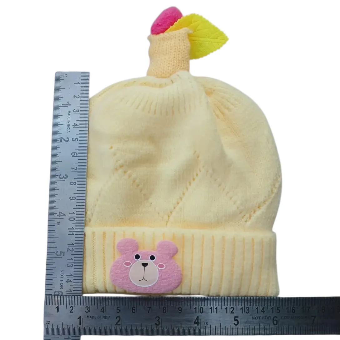 Cream baby winter cap with pink bear patch and decorative topper size