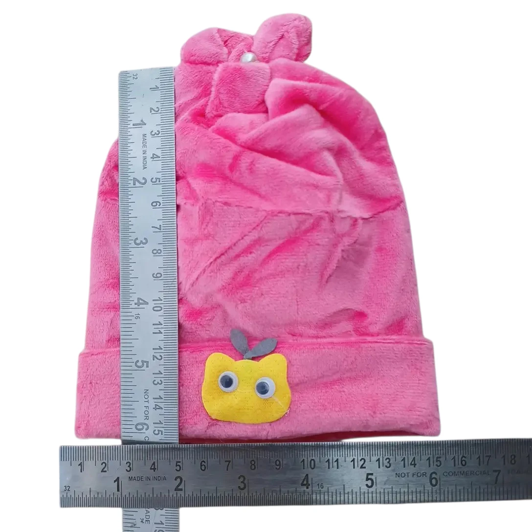 Pink baby winter cap with yellow cartoon face patch and decorative top size